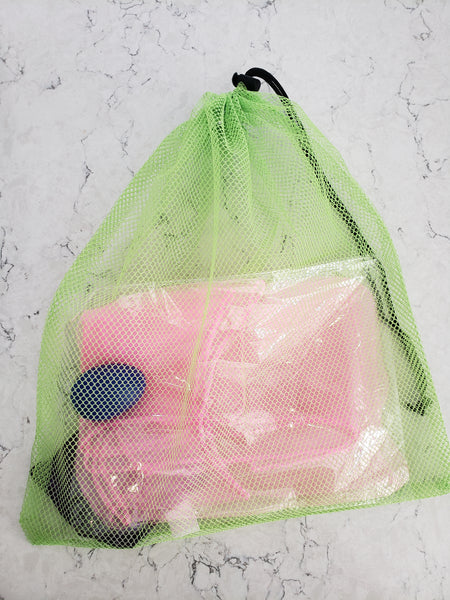 Mesh bag that holds a scarf, egg shaker, and beanbag